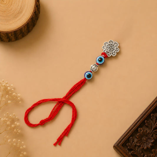 Handcrafted sterling silver floral Bhabhi Rakhi with evil eye beads, decorative silver bead and premium red thread