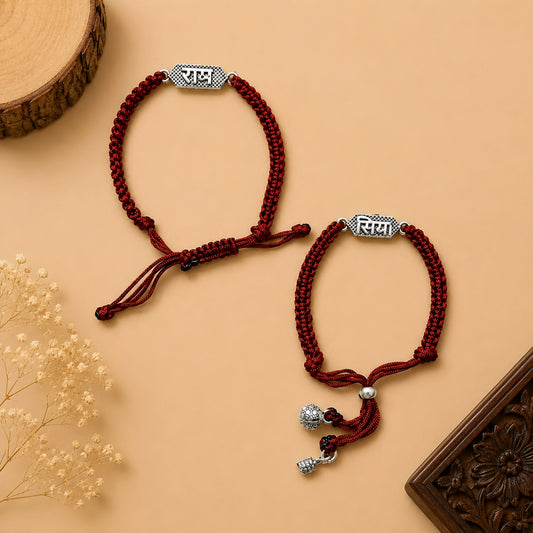 Silver Siya Ram Couple Rakhi Bracelet Set with engraved Siya and Ram nameplates, handcrafted maroon braided thread, adjustable closure and silver charms for Raksha Bandhan