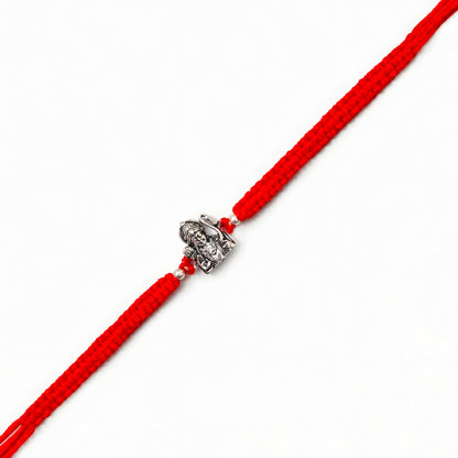 Silver Shri Ram Dhanush Rakhi with Lord Ram bow design and red braided thread for brother on Raksha Bandhan