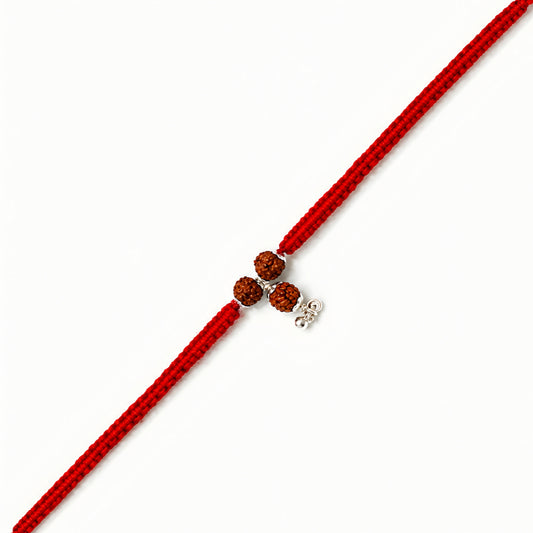 Sterling Silver Rudraksha Lumba Rakhi for Bhabhi with three Rudraksha beads, red woven thread and silver hanging charm