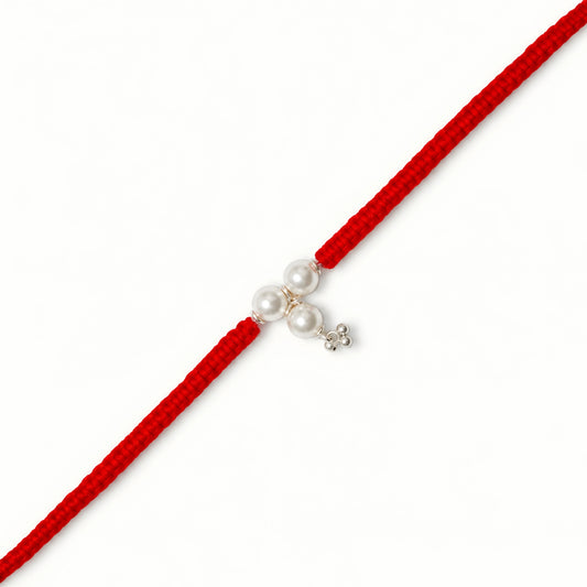 Sterling Silver Triple Pearl Bhabhi Rakhi with three white pearl beads, silver charm and broad red woven thread