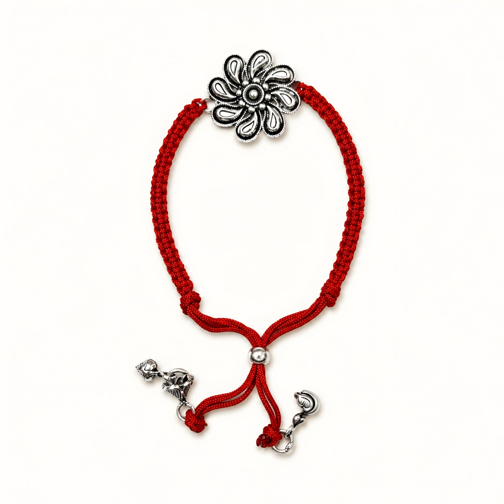 Sterling Silver Floral Lumba Rakhi for Bhabhi with oxidised flower centrepiece, red woven thread and hanging silver charms