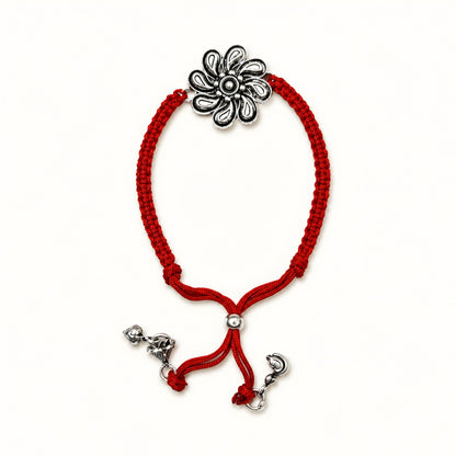 Sterling Silver Floral Lumba Rakhi for Bhabhi with oxidised flower centrepiece, red woven thread and hanging silver charms