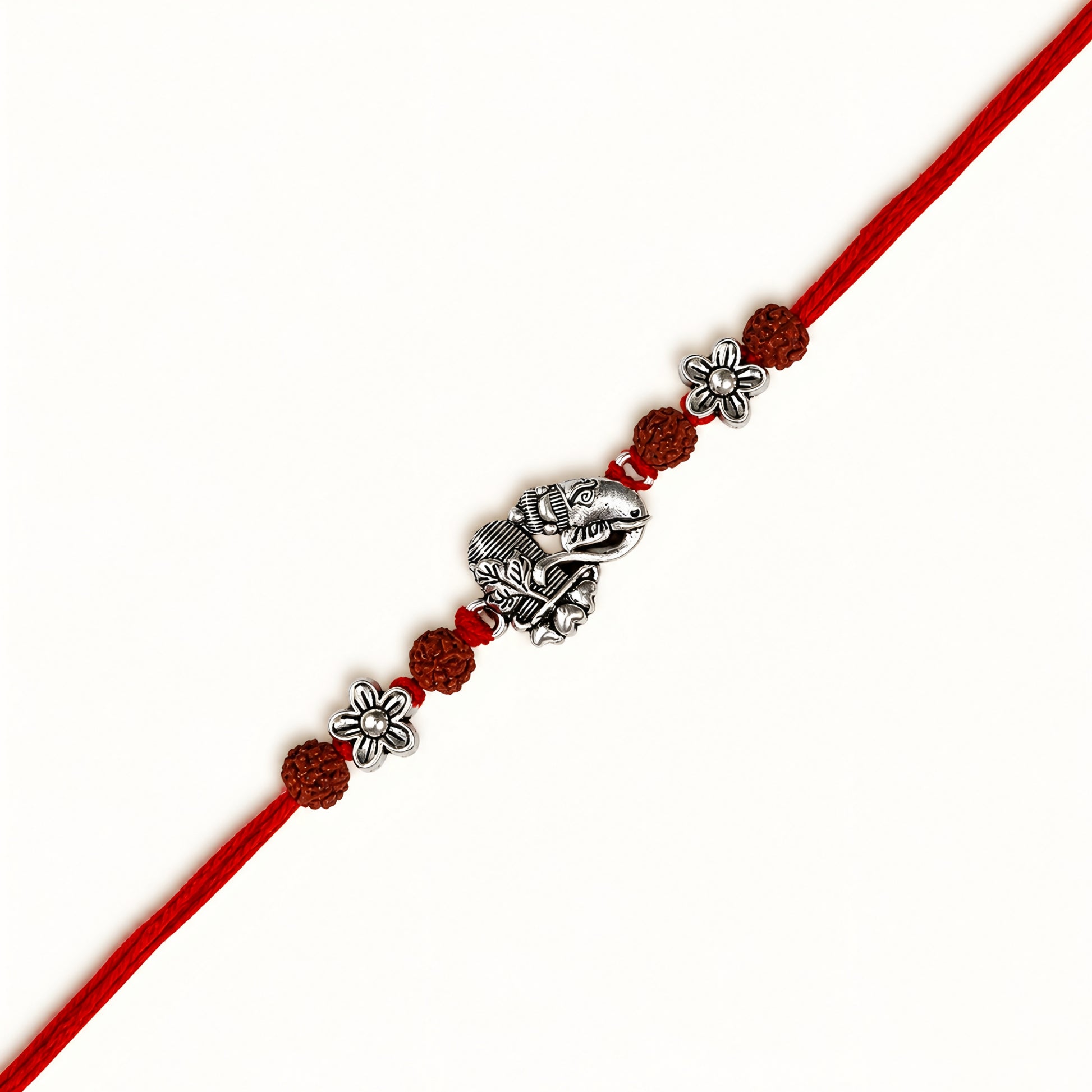 Silver Ganesh Shivling Rakhi with original Rudraksha beads, floral accents and red thread for Raksha Bandhan