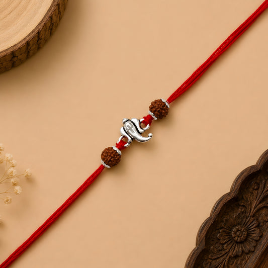 Sterling Silver Ganesh Rudraksha Rakhi with Lord Ganesha centrepiece, two Rudraksha beads and red thread for brother