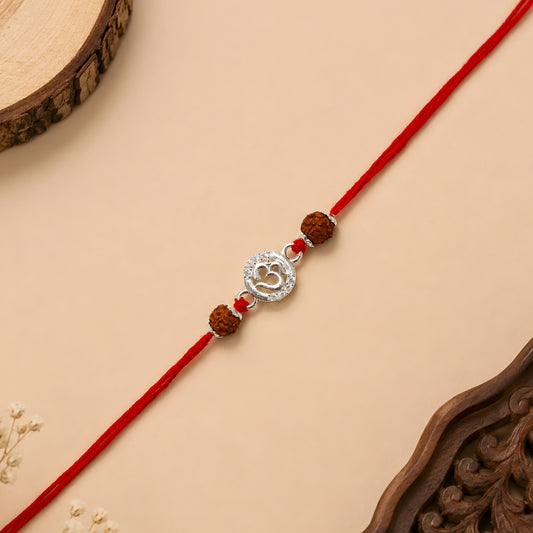 Sterling Silver Om Rudraksha Rakhi with circular silver Om centrepiece, two Rudraksha beads and red thread for brother