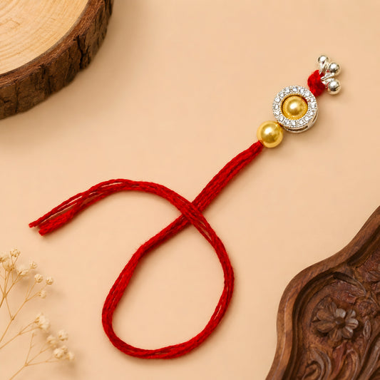 Sterling Silver Golden Halo Lumba Rakhi for Bhabhi with gold-tone beads, clear stone border, silver charms and red thread