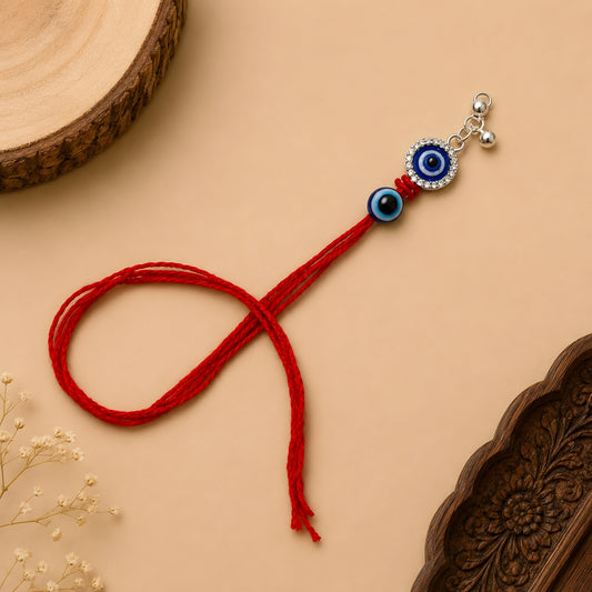 Sterling Silver Dual Nazar Lumba Rakhi for Bhabhi with two blue evil-eye motifs, hanging silver beads and red thread