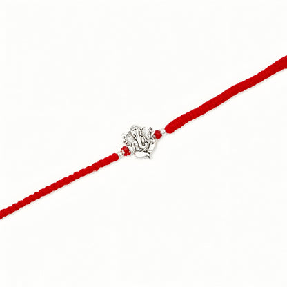 Ganesha silver Rakhi with red braided thread for brother