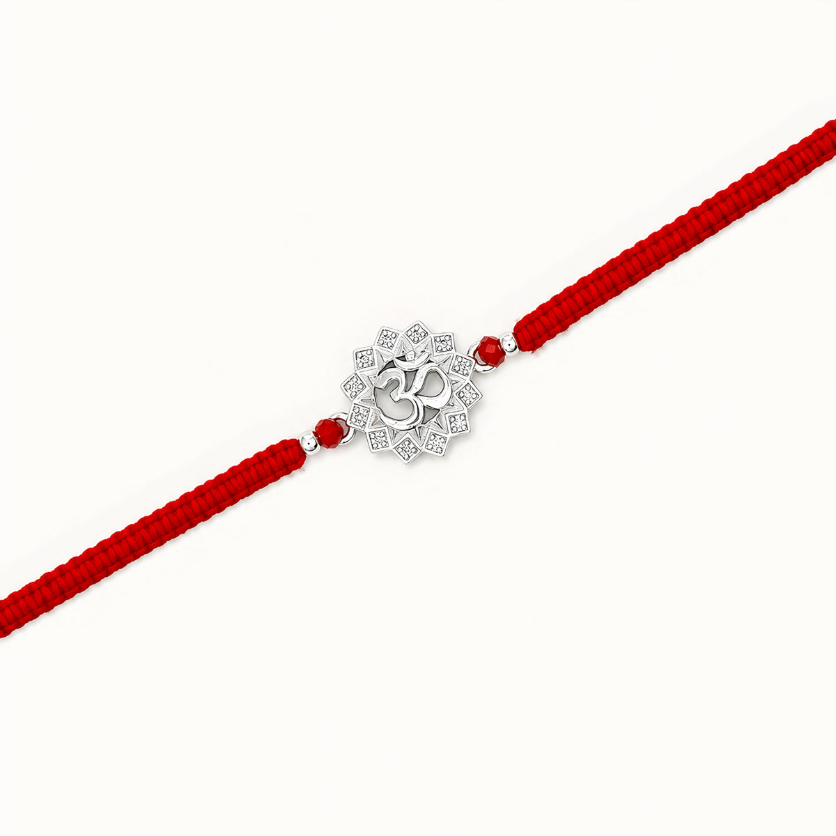 Om silver Rakhi with lotus design and red braided thread for brother