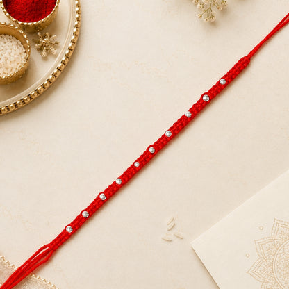 92.5 silver Rakhi with red braided thread and silver bead detailing