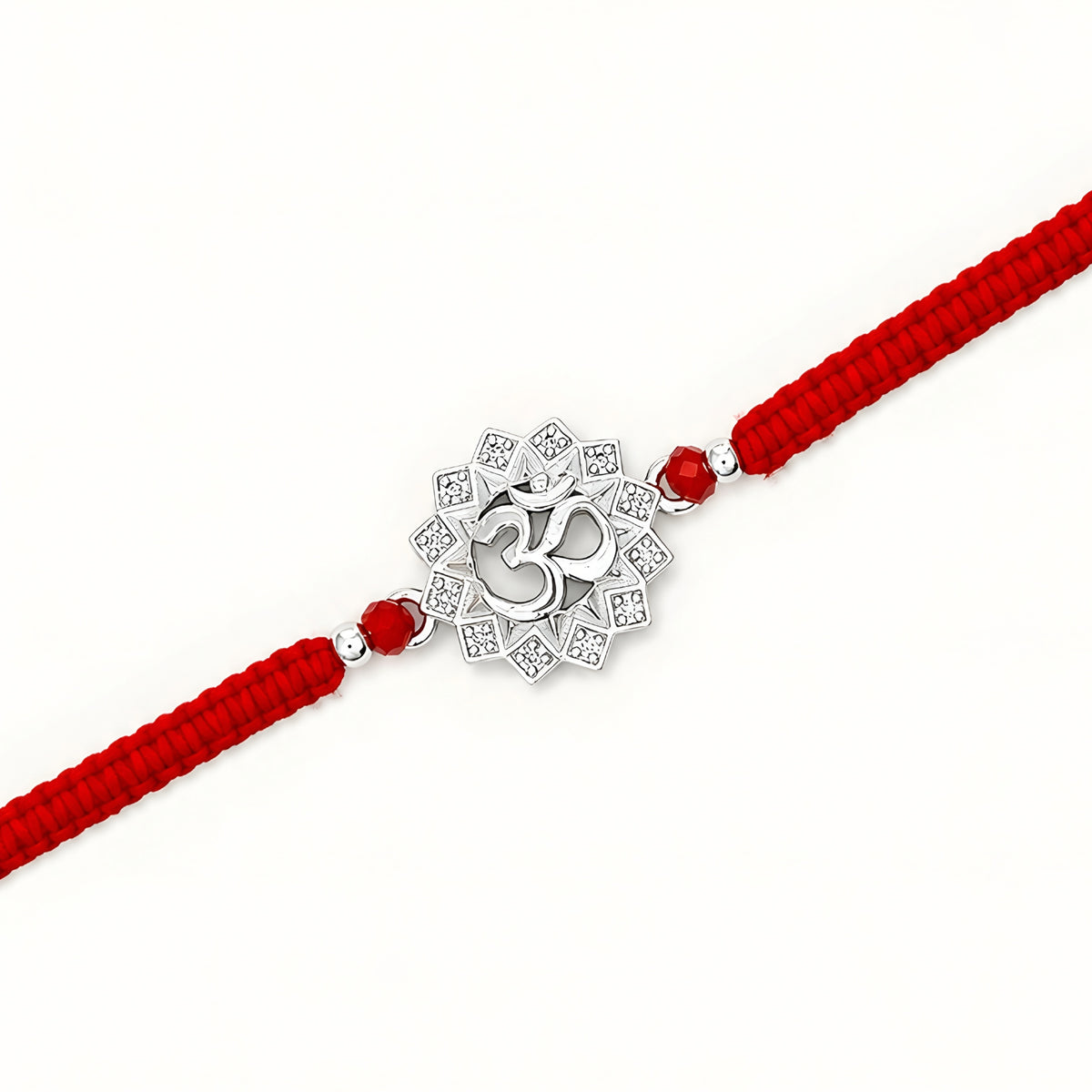Om silver Rakhi with lotus design and red braided thread for brother