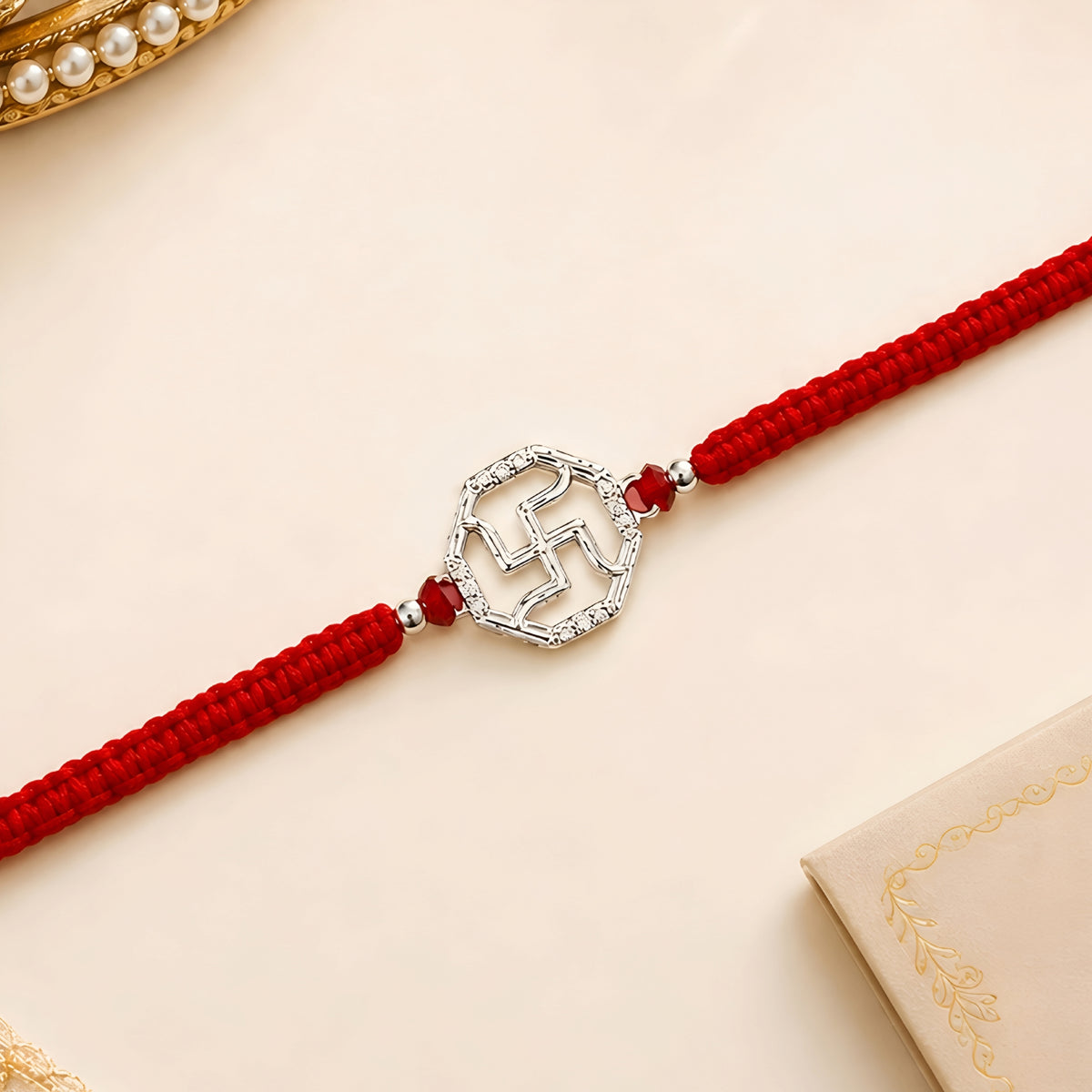 Swastik 925 silver Rakhi with red braided thread for brother