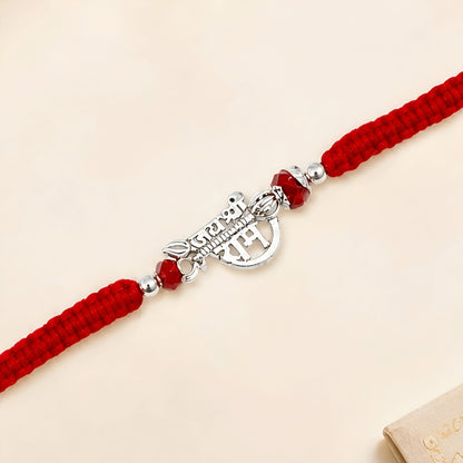 Shree Ram silver Rakhi with red braided thread and silver centerpiece