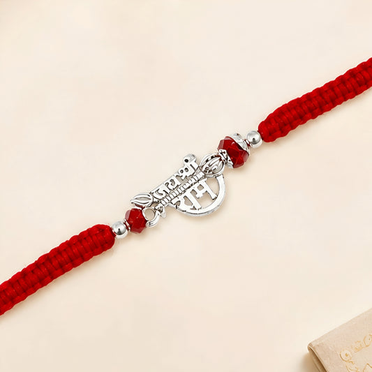 Shree Ram silver Rakhi with red braided thread and silver centerpiece
