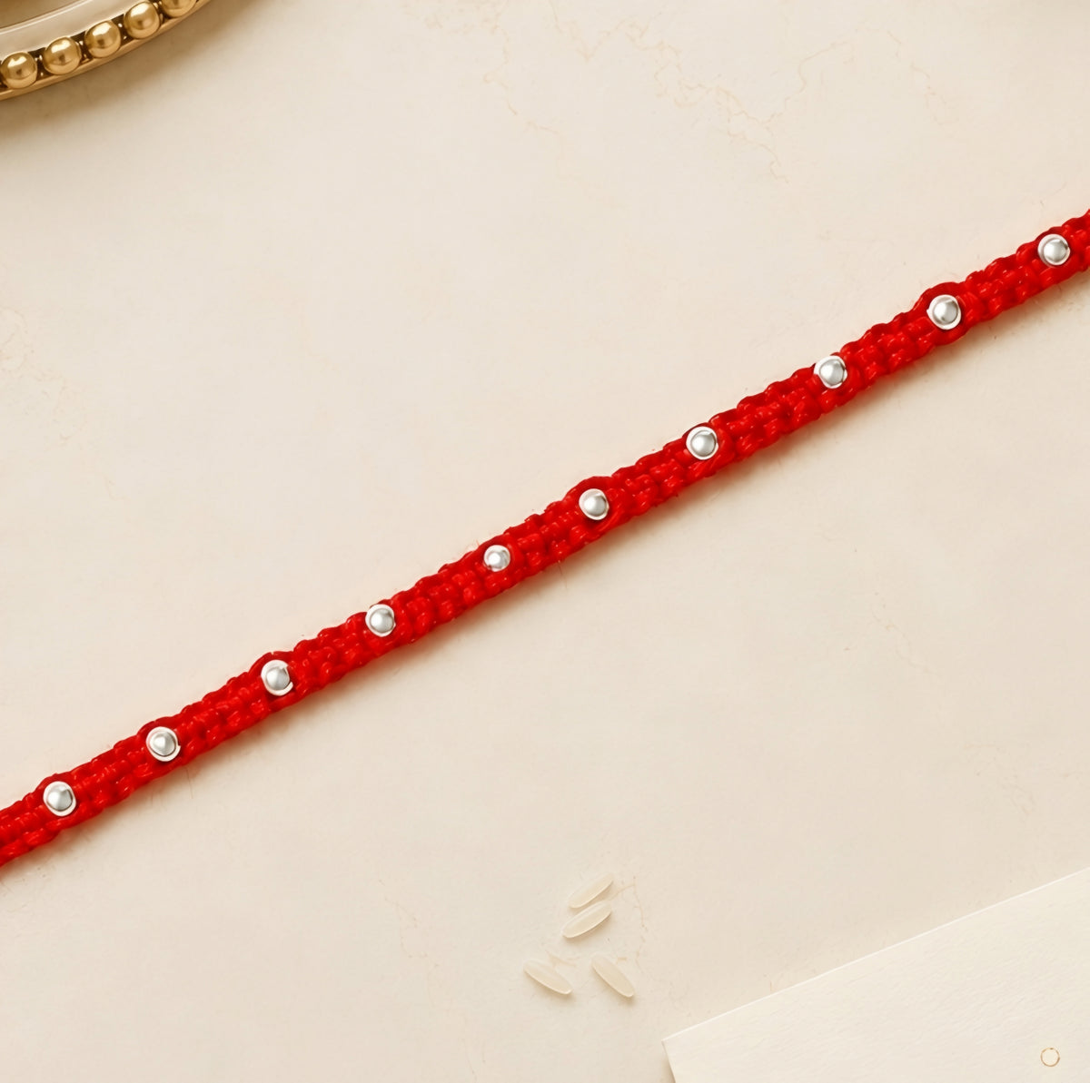 92.5 silver Rakhi with red braided thread and silver bead detailing