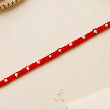 92.5 silver Rakhi with red braided thread and silver bead detailing