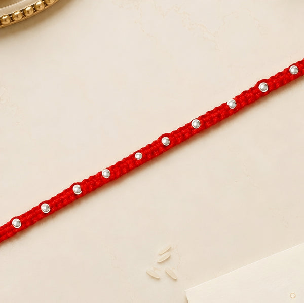 92.5 silver Rakhi with red braided thread and silver bead detailing