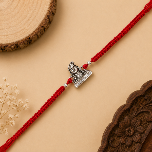 Silver Adiyogi stone Rakhi with Lord Shiva centerpiece and adjustable red thread for brother on Raksha Bandhan