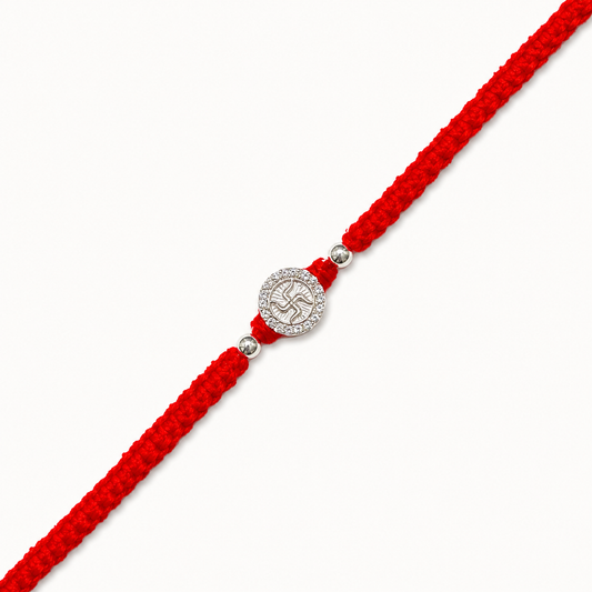 Silver Swastik stone rakhi with sacred Swastik symbol on a handcrafted red braided thread for Raksha Bandhan