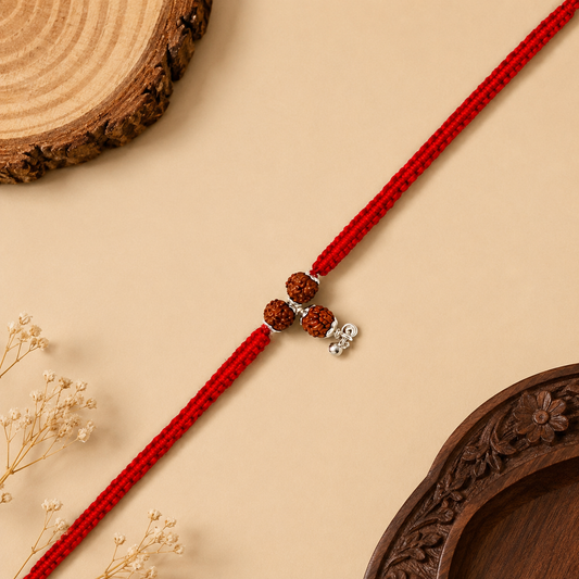 Sterling Silver Rudraksha Lumba Rakhi for Bhabhi with three Rudraksha beads, red woven thread and silver hanging charm