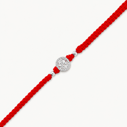 Silver Ganesh Stone Rakhi with sparkling circular design and red braided thread for Raksha Bandhan