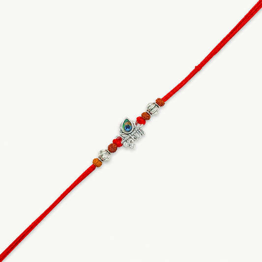 Silver Krishna flute rakhi with peacock feather, original Rudraksha beads and red thread for Raksha Bandhan