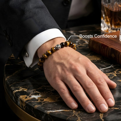 Natural Tiger Eye gemstone bracelet with premium silver accent bead worn on a wrist, featuring polished golden-brown stone beads.