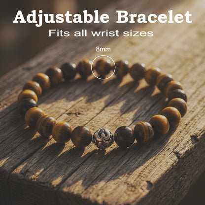 Natural Tiger Eye gemstone bracelet with premium silver accent bead worn on a wrist, featuring polished golden-brown stone beads.